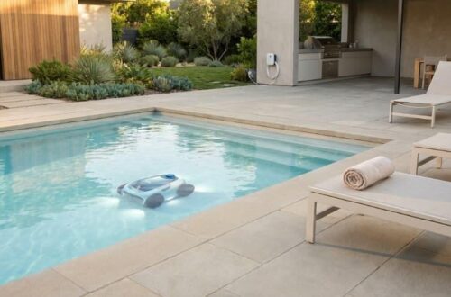 A cordless pool cleaner in a clean and uncluttered backyard pool setup